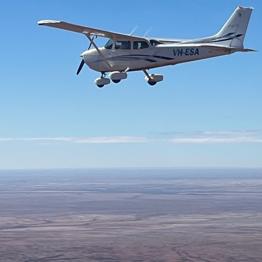 Cessna 172 Skyhawk in flight over the outback